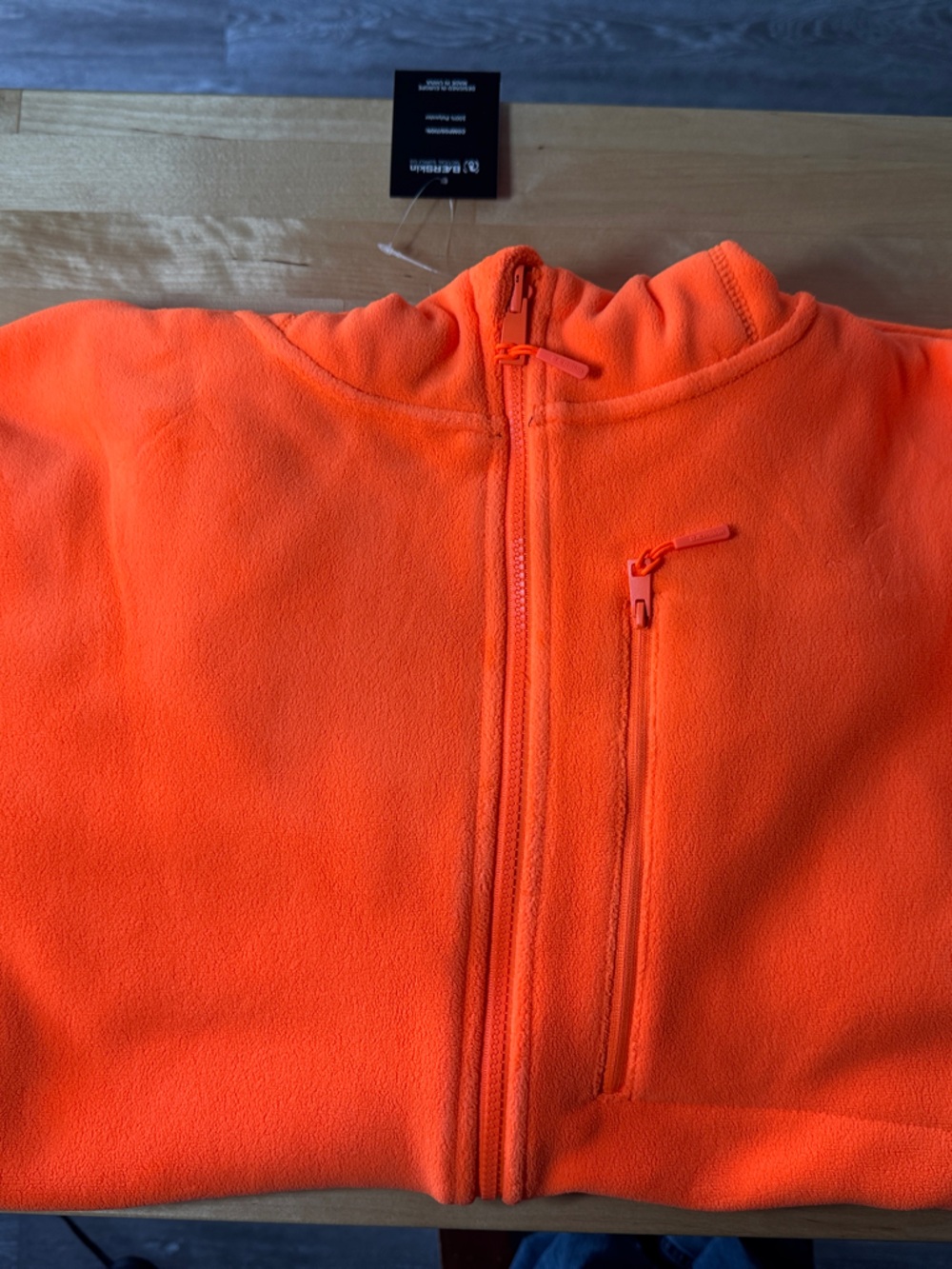 Bright Orange Full-Zip Fleece Jacket with zippers on arms chest and pockets.